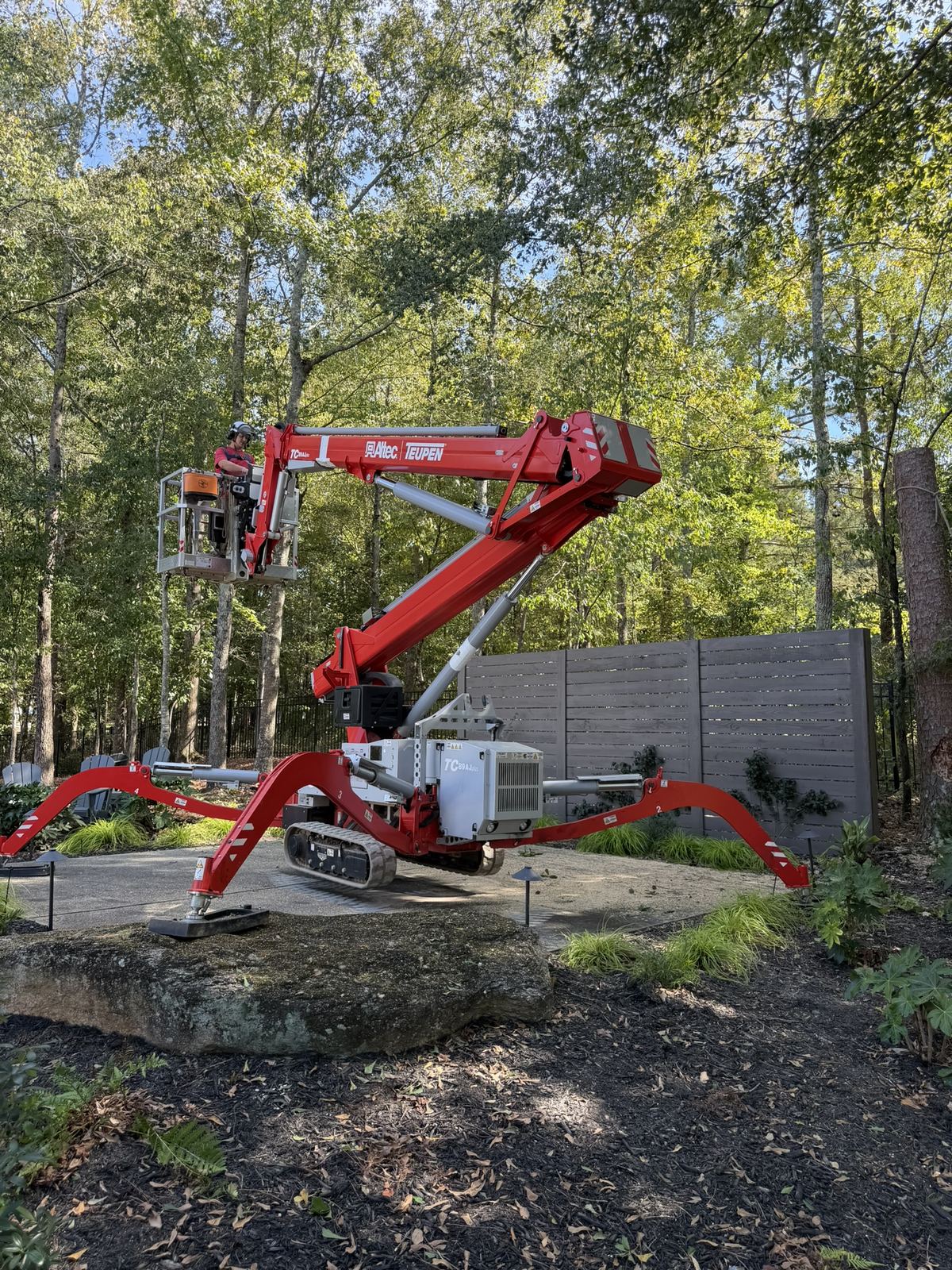 Lift working from a patio in a wooded garden